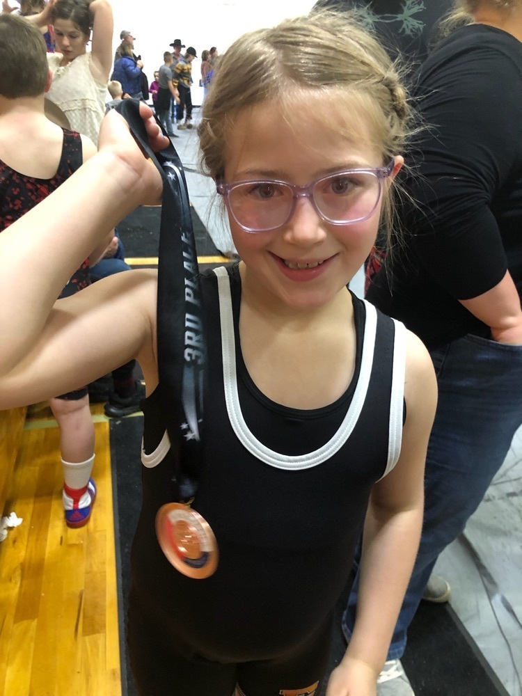 Oakley shows off her medal from wrestling in Crawford.